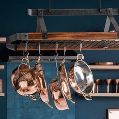 pots and pans hanging from a rack in a kitchen