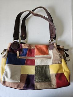 Vintage boho hippie style shoulder bag. Genuine leather, multi color patchwork with shoulder straps. Inside open pockets made for glasses, phone, or accessories. Outside zipper pocket. Gently used, very clean. Two small marks on leather squares shown in pictures, vintage wear on shoulder straps also shown. Multicolor Patchwork Hobo Bag For Everyday Use, Multicolor Patchwork Hobo Bag For Daily Use, Multicolor Patchwork Tote Satchel, Colorful Patchwork Shoulder Bag For Daily Use, Colorful Patchwork Shoulder Bag For Everyday Use, Multicolor Patchwork Satchel Shoulder Bag, Daily Use Multicolor Patchwork Hobo Bag, Casual Multicolor Patchwork Hobo Bag, Multicolor Patchwork Satchel For Daily Use