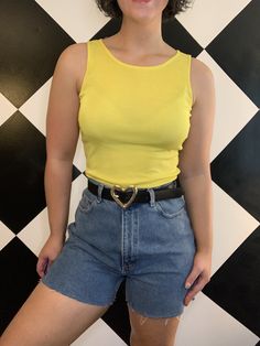 "That 1990s neon just hits different. Vintage 1990s neon yellow silky feel tank top. The color is so vibrant and eye catching, I just love it! Very simple tank; crew neck with simple cut sleeveless, straps are 1.25in in the thinnest part. Nice small ribbed texture to the material with a lot of stretch, it is 95% polyester and 5% spandex. In very good condition, just a few threads loose at the hem. The tag is fairly faded so I cannot see a size, but I am thinking a modern small. From \"NY-5\". Measurements (in inches, laying flat): Width: 16.5-24 Length: 21" Y2k Crew Neck Tank Top For Summer, Retro Stretch Summer Tank Top, Retro Stretch Tank Top For Summer, Y2k Tank Top For Spring, Y2k Style Tank Top With Tank Straps For Spring, Y2k Style Tank Top For Spring, Basic Spring Vest With Scoop Neck, Basic Scoop Neck Vest For Spring, Fitted 90s Style Tank Top For Spring