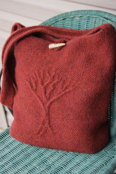 a red bag sitting on top of a blue chair