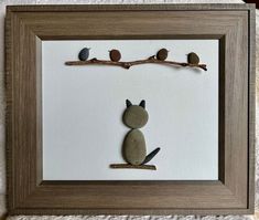 a cat sitting on top of a rock under a tree branch with birds perched on it