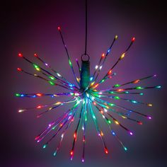 a multi - colored chandelier with lights hanging from it's center point