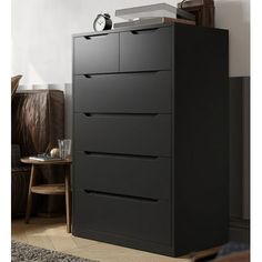 a black chest of drawers in a living room