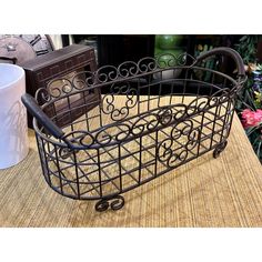 a metal basket sitting on top of a table