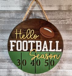 a wooden sign that says hello football season