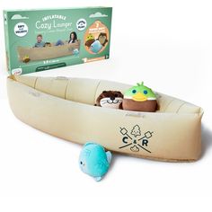 an inflatable boat with two stuffed animals inside it and a box on the side