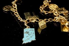 This is a very beautiful, very unique and vintage GF STERLING LINK  charms bracelet. The bracelet has marvelous 9 charms with zodiac, happy birthday, Indiana state, I AM LOVED, locked, college cap, sky girl and gilt starling, gold filled. The bracelet has a very exotic and elegant feel to it. It measures 7" long. The bracelet is in very good condition. 0.7 MR Vintage Charm Bracelet Zales, Antique Good Luck Charms Jewelry, Gold Charm Bracelet As A Souvenir, Antique Personalized Jewelry Collectible, Vintage Personalized Jewelry For Collectors, Vintage Gold Charm Bracelet Gift, Heirloom Charms Jewelry For Collectors, Antique Hallmarked Charm Bracelet As Gift, Vintage Personalized Gold Charm Bracelet