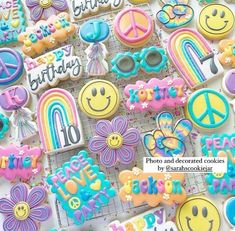 there are many decorated cookies with happy birthday written on them and smiley faces in the middle