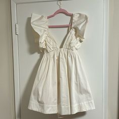 Baby Doll White Dress, Never Worn. With Tag. Tried On But Never Wore And Never Returned Because I Forgot! Size Small - Runs True To Size With Room Because It Has Stretchy Band Cream Cotton V-neck Mini Dress, Cotton Mini Dress With Ruffles For Date Night, White V-neck Cute Dress, Off-white Cotton Dress For Brunch, Cute White V-neck Dress, Off White Cotton Dress For Brunch, Summer Ruffle Dress In Off White, Beige Cotton Mini Dress For Party, Beige Cotton Party Mini Dress