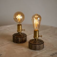 two light bulbs sitting on top of a table