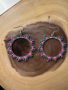 "Greta Van Fleet \"Flower Power\" inspired beaded hoop dangle earrings Made with green, pink, and yellow beads to look like flowers Wearing these groovy earrings will make you feel like you're alive! You're outta sight! 40 mm hoops, 2 1/2 inch dangle Handmade with love  ♡She's alright, she's outta sight♡" Adjustable Flower Beaded Earrings For Festivals, Pink Beaded Earrings For Summer, Handmade Small Hoop Beaded Earrings For Summer, Pink Flower Earrings With Colorful Beads For Summer, Green Flower Hoop Earrings For Gift, Festival Flower Shaped Jewelry With Ear Wire, Green Beaded Earrings For Summer, Bohemian Hoop Flower Earrings With Ear Wire, Flower Shaped Festival Jewelry With Ear Wire