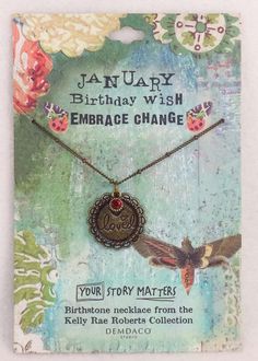 a necklace with a bird on it and the words, january birthday wish embrace change