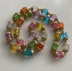 a multicolored bracelet with lots of stones on it's end and clasp