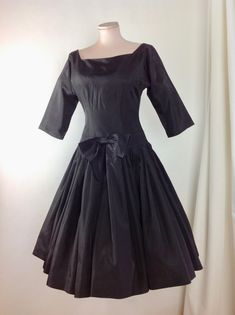 1950's Black Taffeta Cocktail Dress with a fitted bodice and a drop waist, a full pleated skirt, square cut-out neckline.. Wow. Such a beautiful dress!! There is a metal zipper that runs down the back of this dress for that perfect tailored hourglass fit. This garment is in EXCELLENT VINTAGE CONDITION. There are no stains, holes, repairs or snags. *There is no fashion label in this dress. There is a size label that is marked size 14.. lol.. ( of course this is sizing from the 1950's, and in toda Evening Dress With Accordion Pleats And Full Skirt, Fitted Square Neck Dress With Gathered Skirt, Formal Dresses With Accordion Pleats And Full Skirt, Formal Full Skirt Dress With Accordion Pleats, Black 1950s Style Wedding Dress, Accordion Pleated Full Skirt Party Dress, Full Skirt Dress With Accordion Pleats For Party, Classic Fitted Dress With Accordion Pleats, 1950s Style Full Skirt Vintage Dress