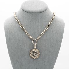 This vintage button necklace features a collectable vintage silver metal mirrored button with a delicate scroll design in the center and flower design on the ends securely attached to a large antiqued silver pendant displaying craftsmanship reminiscent of a bygone era. A vintage silver barbed wire style chain completes this vintage necklace with large lobster clasp For an effortlessly chic look wear this a one-of-a-kind silver statement necklace alone or layered with other jewelry or give this h Victorian Antique Silver Nickel-free Necklace, Vintage Metal Medallion Necklace With Coin Pendant, Victorian Silver Necklace With Antique Finish, Vintage Metal Coin Pendant Necklace, Silver Necklaces With Coin Pendant For Vintage Collection, Ornate Antique Silver Medallion Necklace, Silver Antique Locket Necklace With Vintage Charm, Ornate Antique Silver Pendant Locket Necklace, Antique Silver Vintage Charm Pendant Locket Necklace