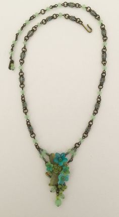 Petite delicate pendant style necklace with pretty mixed hues of green, turquoise and sea foam green. The flowers are hand painted and the entire necklace is beaded with thread and wire. Including the necklace itself. This is a nice style for a more petite body or someone who wants a necklace that is more delicate. This necklace would look great with a pretty summer dress or can be worn casually with even a pair of jeans. Earrings on the model are also available. This is a quality piece of jewel Whimsical Green Flower Jewelry, Adjustable Turquoise Flower Pendant Jewelry, Whimsical Green Pendant Jewelry, Unique Green Flower Pendant Jewelry, Green Delicate Flower Jewelry, Bohemian Green Necklace With Czech Glass, Green Flower Pendant Necklace As Gift, Unique Green Adjustable Necklace, Green Flower Pendant Necklace For Gift