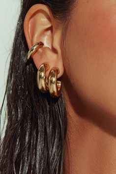 The pair to swear by. Sleek and sculptural - even in its lobe-hugging minutiae. Our gold-filled tube huggies are the most versatile earring you’ll ever own. Stack with hoops, cuffs or studs, wear just as accent pieces, or double up with our sterling silver version for a modern touch of tonal duality. Jewelry Collection Handcrafted in Brazil 18k Gold Filled Thickness: 7mm Diameter: 1" Weight: 0.20 oz Waterproof Hypoallergenic Gold Tarnish-resistant Small Hoop Ear Cuff, Stack Jewelry, Gold Statement Jewelry, Multiple Earrings, Modern Gold Jewelry, Stacked Earrings, Chunky Earrings, Naked Wardrobe, Gold Ear Cuff