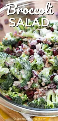 broccoli salad with cranberries and onions in a glass bowl on a wooden table