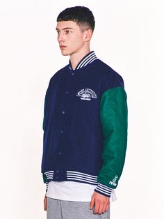 Editor's Notes Featuring various embroidered logo graphics, this casual varsity jacket is made from wool-blend with lightly padded lining for warmth. It's constructed with classic color-blocking body and sleeves with sporty striped ribbed edges.- Snap button fastenings- Two front welt pockets- Logo embroidery on the chest, sleeve and back- Logo labels on the hem and back- Striped ribbed edges- Drop shoulder- Relaxed fitMeasurements (in.) 2 / 3- Total Length: 26.0 in. / 27.2 in. - Shoulder: 22.8 in. / 24.4 in.- Chest: 25.2 in. / 26.8 in.- Sleeve Length: 22.8 in. / 23.6 in.Model info: 5' 11.7, 132.3 lbs / Fitting size 3Composition & Care- Shell: 50% Acrylic, 50% Wool- Lining: 100% Polyester- Filling: 100% Polyester- Dry clean only- Refer to the care labelDesigner- by FREAKISH BUILDING Winter Varsity Jacket With Patchwork, Varsity Style Long Sleeve Outerwear With Contrast Color, Winter Cotton Varsity Jacket With Patchwork, Winter Varsity Jacket With Patchwork And Baseball Collar, Varsity Patchwork Outerwear For College, College Style Patchwork Varsity Jacket For Fall, Fall College Style Varsity Jacket With Patchwork, College Style Cotton Outerwear With Embroidered Logo, Throwback Long Sleeve Track Jacket For College