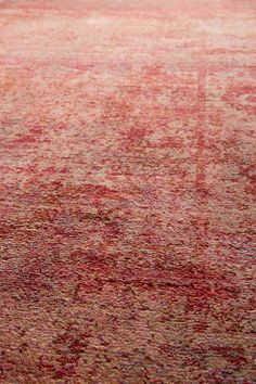 an area rug with red and beige colors