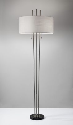 Three brushed steel poles extend through a beautifully textured white fabric shade creating the unique, yet elegant silhouette of the Anderson Floor Lamp. A double socket holds two 100 Watt bulbs that can be turned on and off with double pull chain switches. A black marble base adds a decorative accent to the simple style. Adesso Anderson 71-in Brushed Steel Floor Lamp Marble | 4073-22 Elegant Floor Lamps, Traditional Floor Lamps, Traditional Lamps, Pallet Shelves, Metal Floor Lamps, Led Floor Lamp, Modern Country, Pull Chain, Modern Lamp