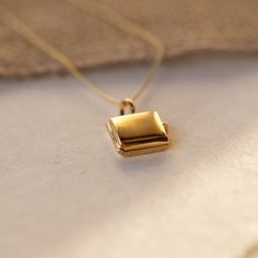 LOCKET FEATURES gold square pendant locket  14k gold vermeil on sterling silver holds one or two picture photos closes to keep the photos secret unless opened .5" wide x .5" tall x .2" deep (.7" from bottom to top of bale) 18" dainty 14k gold-fill chain  also available in silver we secure your photo inside in your locket with a protective resin pro tip: this locket works best with a photograph that could be cropped to a square (a small one!)  comes with a polishing cloth to care f Yellow Gold Necklace With Box Clasp Gift, Gold Rectangular Necklace For Keepsakes, Gold Rectangular Keepsake Necklace, Gold Rectangular Locket Necklace, Gold Rectangular Jewelry Keepsake, Gold Rectangular Keepsake Jewelry, Formal Rectangular Locket Necklace, Gold Rectangular Locket Necklace For Gifting, Square Pendant Locket Jewelry For Anniversary