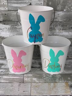 three buckets with painted easter bunnies on them