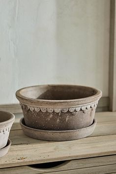 two bowls sitting on top of a wooden table