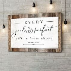 a wooden sign that says every good and perfect gift is from above on a brick wall