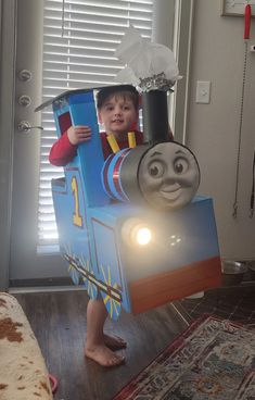 a child in a thomas the tank engine costume