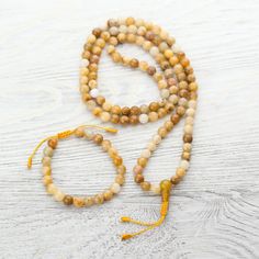 Harness the warmth and powerful energy of the sun with this golden Yellow Jade 108 bead mala necklace handcrafted in Kathmandu. This mala emits a sunny yellow energy and helps to rejuvenate the Solar Plexus Chakra that enables you to feel joyful, warm and energetic. Whether you wear it around your neck or wrap it around your wrist, Yellow Jade is believed to bring good fortune, happiness, and self-confidence to those who carry it. Yellow Jade is is a motivational stone that encourages expression Bottling Up Emotions, Yellow Energy, The Solar Plexus Chakra, Jade Mala, Wrist Mala, Large Bracelet, Adjustable Knot, Yellow Jade, 108 Mala Beads