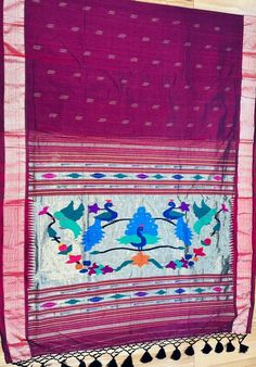 an old purple cloth with birds and flowers on it