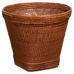 a brown wicker basket on a white background