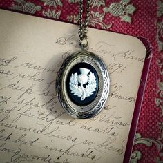 "Cameo on a vintage brass, antiqued or shiny silver-plated oval locket, perfect for remembering your loved ones. On 28 inches of chain. Choose your desired color. I can change the chain to any length, just leave a note at checkout. Great for pictures of your loved ones. Simply print, cut out and attach a photo with glue. We do not offer printer services at this time. Fits a 17mm by 24mm oval photo. The box will include an oval stencil that will help you cut out your photo. I carry a great select Oval Cameo Keepsake Jewelry, Antique Silver Necklace With Vintage Charm, Antique Silver Oval Necklace With Vintage Charm, Antique Silver Necklaces With Oval Vintage Charm, Antique Silver Necklace With Vintage Charm In Oval Shape, Victorian Oval Nickel-free Necklaces, Cameo Locket Necklace As Gift, Cameo Oval Pendant Locket Necklace Gift, Oval Cameo Locket Necklace Gift