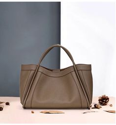 Discover luxury fashion with this designer leather bag. Crafted with 100% genuine leather, this tote & shoulder bag is perfect for making a statement. This bag is designed with strong and sturdy handles to keep your essentials safe. Perfect for any occasion, this bag is sure to impress. Designed by 4COLORDRESS High-end Shoulder Satchel, High-end Double Handle Satchel For Shopping, High-end Bucket Bag With Handles For Daily Use, High-end Bucket Bag For Daily Use, Luxury Bucket Bag With Large Capacity And Top Handle, High-end Large Capacity Shoulder Bag For Shopping, Luxury Large Capacity Bucket Bag With Top Handle, Luxury Large Capacity Top Handle Bucket Bag, High-end Satchel Shoulder Bag For Shopping