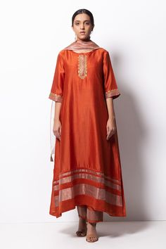 Rust orange kurta highlighted with zardozi embroidery, round neckline and straight silhouette. Comes with cotton silk pant, chanderi dupatta and inner slip.
Component: 4
Pattern: Embroidered
Type Of Work: Zardozi
Neckline: Round
Sleeve Type: Three Quarter
Fabric: Kurta: Handwoven Chanderi Silk; Dupatta: Chanderi; Pant: Cotton Silk
Color: Orange
Other Details: 
Straight kurta
Concealed placket
Side pockets
Asymmetric hem
Contrast hem pant
Dupatta with tassels
Occasion: Mehendi and Haldi, Puja - A Silk Kurta Set, Pakistani Kurta, Zardozi Embroidery, Cotton Kurti Designs, A Line Kurta, Silk Kurta, Kurta Designs Women, How To Hem Pants, Silk Dupatta