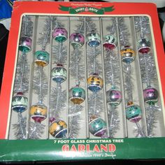 an assortment of glass christmas ornaments in a box