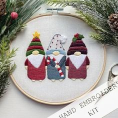 an embroidery kit with three gnomes on it