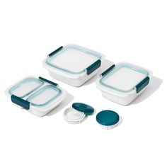 three white and blue dishes with lids, one on the left and one on the right