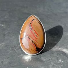 Large chocolate jasper ring  Origin - Indonesia  Metal - 925 sterling silver  Weight - 18.4 grams  Dimensions -  L 3.7 x B 2.5 x H 0.7 cm  L 1.45 x B 1 x H 0.3 inch Ring size - U.K. - P 1/2 adjustable  US - 8 adjustable  EU - 17 / 57 adjustable  Band width - 1 - 0.5 cm  Handmade  Post - track Unique Jasper Rings For Gift, Brown Large Stone Ring Jewelry, Brown Large Stone Ring, Brown Natural Stone Ring, Brown Natural Stone Rings, Adjustable Oval Rings In Brown, Unique Brown Rings For Gift, Jasper Gemstone Rings Gift, Unique Brown Oval Rings