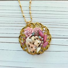 Thoughtfully curated mosaic of vintage pieces creating a stunning and eye-catching handmade pendant in a soft blush color palette hung on 33-inch gold plated chain. Gorgeous vintage vibe! Only one of its kind! Makes a great gift or treat yourself! Thanks for looking! Whimsical Pendant Necklace With Vintage Charm, Whimsical Vintage Charm Pendant Necklace, Pink Vintage Charm Pendant Jewelry, Rose Gold Pendant Necklace With Vintage Charm, Unique Gold Necklaces From Vintage Collection, Unique Gold Necklaces With Vintage Charm, Personalized Vintage Pink Jewelry, Whimsical Gold Jewelry With Vintage Charm, Vintage Handmade Initial Pendant Jewelry