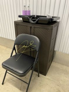 a black folding chair sitting next to a record player