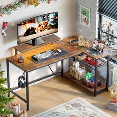 a computer desk with a keyboard and mouse on it in front of a christmas tree