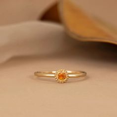 a close up of a gold ring on a white cloth