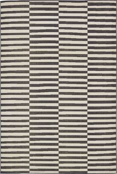 a black and white rug with vertical stripes on the bottom, in various shades of grey