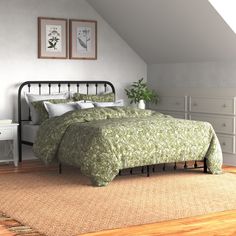 a bed sitting in a bedroom next to a white dresser and lamp on top of a hard wood floor