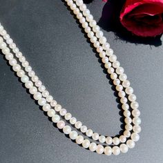 Featuring a timeless classic 2 line pearl string necklace. Must have for every women, this aesthetic piece pairs well with Indian as well as Western outfits. Crafted with love, this 2 line pearl string necklace will complete any look while adding a touch of elegance and sophistication. An essential addition to any wardrobe. Length 42 CM Weight of pearls - 62.60 GMs Anniversary Pearl White Double Strand Necklace, Double Strand Pearl Necklace For Formal Occasions, Formal Double Strand Pearl Necklace With Pendant, Classic Double Strand Wedding Necklaces, Formal Double Strand Pearl Necklace, Double Strand Akoya Pearl Necklace, Timeless Pearl Chain Necklace For Anniversary, Timeless Single Strand Pearl Necklace For Wedding, Classic Bridal Pearl Necklace In Pearl White