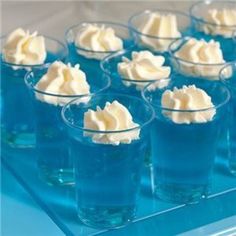 small cups filled with whipped cream sit on a blue tray