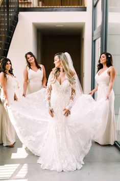 the bridesmaids are getting ready to walk down the aisle in their wedding gowns