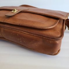 "Vintage Coach Original Metropolitan Brief Bag British tan leather with brass hardware Roomy interior with inner slip pocket, one outer pocket covered by a flap and secured by a turnlock Top handle Full back pocket Adjustable 46\" strap Measures: 15\"L, 11\"H, 2\"W Made in the United States #0348 928 Flaws: minor pen marks on inner flap and a few on front flap Questions? Just ask More vtg coach styles/colors also available" Classic Bag With Double Flap For Daily Use, Classic Double Flap Bag For Daily Use, Classic Cognac Shoulder Bag With Gold-tone Hardware, Classic Everyday Briefcase With Brass Hardware, Leather Saddle Bag With Turn-lock Closure For Work, Leather Saddle Bag With Turn-lock For Work, Classic Briefcase With Brass Hardware For Everyday, Classic Double Flap Bag, Classic Cognac Flap Bag With Gold-tone Hardware